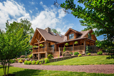 Mid-sized mountain style brown two-story wood exterior home photo in DC Metro with a hip roof