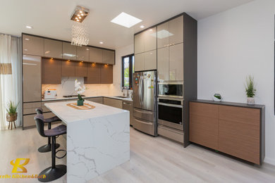 Inspiration for a mid-sized modern l-shaped vinyl floor and gray floor kitchen remodel in San Francisco with an undermount sink, glass-front cabinets, beige cabinets, quartzite countertops, white backsplash, stone slab backsplash, stainless steel appliances, an island and white countertops