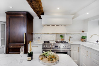 Medium sized classic u-shaped kitchen/diner in Gloucestershire with a double-bowl sink, recessed-panel cabinets, dark wood cabinets, marble worktops, white splashback, marble splashback, stainless steel appliances, an island, grey floors and white worktops.