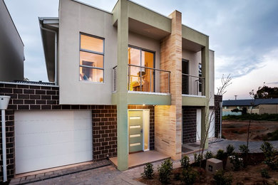 Mid-sized contemporary two-storey brick exterior in Adelaide.