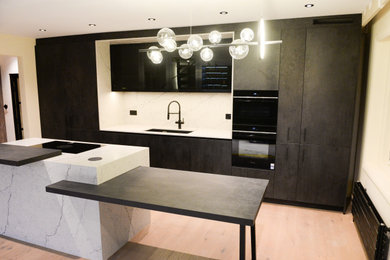 Bespoke deign Kitchen with island and arty lighting.