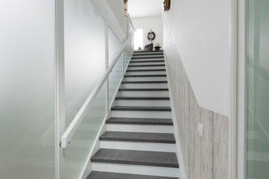 Mid-sized modern wood straight staircase in Frankfurt with wood railing.