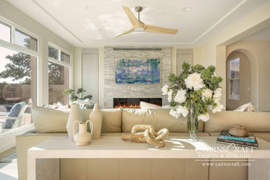 Large beach style open concept medium tone wood floor, beige floor and coffered ceiling family room photo in San Diego with white walls, a ribbon fireplace, a stone fireplace and a media wall