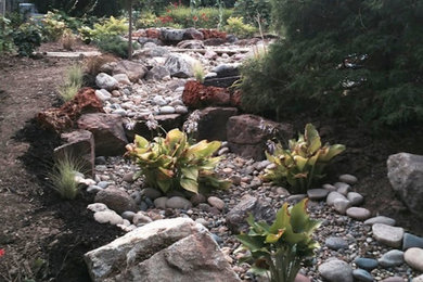 This is an example of a large traditional drought-tolerant and partial sun backyard gravel garden path in Omaha for spring.