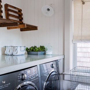 Classic galley utility room in Boston with concrete worktops, white walls, marble flooring, a side by side washer and dryer and blue floors.