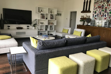Photo of a large contemporary open concept living room in Melbourne with white walls, medium hardwood floors, brown floor and a wall-mounted tv.