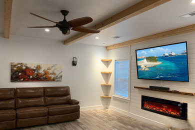 Large transitional vinyl floor, gray floor, exposed beam and shiplap wall basement photo in Atlanta with a shiplap fireplace