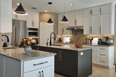 Large cottage u-shaped travertine floor and beige floor eat-in kitchen photo in Austin with an undermount sink, shaker cabinets, white cabinets, quartzite countertops, beige backsplash, stainless steel appliances, two islands, beige countertops and stone slab backsplash