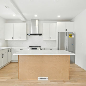 L-Shaped White Kitchen with Center Island