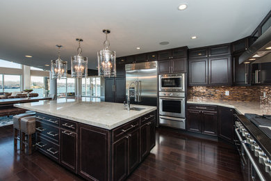 Open concept kitchen - huge contemporary l-shaped dark wood floor open concept kitchen idea in Baltimore with an undermount sink, dark wood cabinets, quartzite countertops, multicolored backsplash, glass tile backsplash, stainless steel appliances and an island