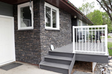 Inspiration for a transitional gray stone exterior home remodel