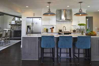 Example of a transitional dark wood floor kitchen design in New York with stone slab backsplash, stainless steel appliances and an island