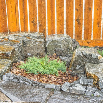 Maintenance-Free Front Yard Featuring Custom Stonework & Shrub