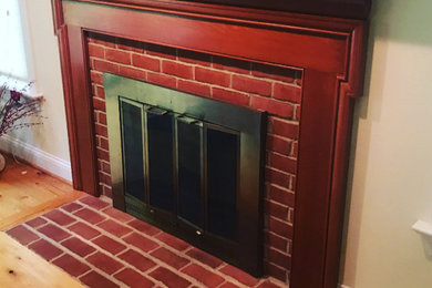 Inspiration for a timeless living room remodel in Wilmington with a standard fireplace and a wood fireplace surround