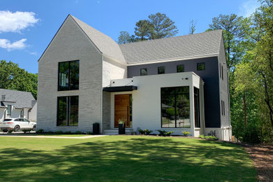 Example of a mid-sized transitional white three-story board and batten and wood exterior home design in Atlanta with a shingle roof and a gray roof