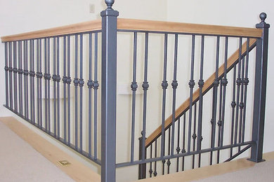 Example of a classic metal railing staircase design in San Diego