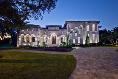 Inspiration for a huge rustic white two-story exterior home remodel in Orlando