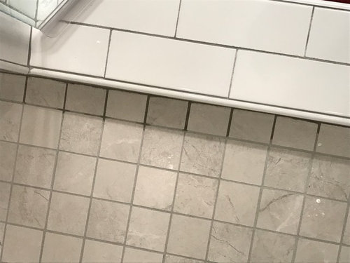 Bad tile job...help! Grout dark in certain areas/chipped tile cuts ...