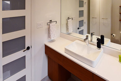 Photo of a mid-sized contemporary 3/4 bathroom in Toronto with an open shower, porcelain tile, porcelain floors, flat-panel cabinets, brown cabinets, white walls, a vessel sink and granite benchtops.