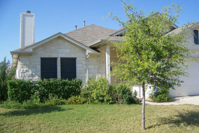 Inspiration for a mid-sized timeless white one-story mixed siding exterior home remodel in Austin with a shingle roof