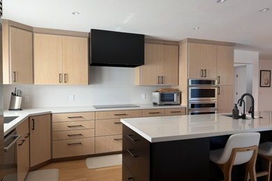 Inspiration for a mid-sized modern l-shaped medium tone wood floor and brown floor eat-in kitchen remodel in San Francisco with an undermount sink, flat-panel cabinets, light wood cabinets, quartz countertops, white backsplash, porcelain backsplash, stainless steel appliances, an island and white countertops