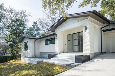 Inspiration for a transitional white one-story brick gable roof remodel in Austin
