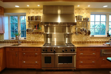 Eat-in kitchen - mid-sized traditional u-shaped eat-in kitchen idea in Baltimore with medium tone wood cabinets, brown backsplash, stainless steel appliances, shaker cabinets, mosaic tile backsplash, an undermount sink and an island