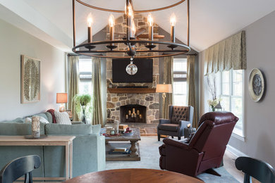 Design ideas for an expansive transitional open concept family room with grey walls, medium hardwood floors, a standard fireplace, a stone fireplace surround, a wall-mounted tv and brown floor.