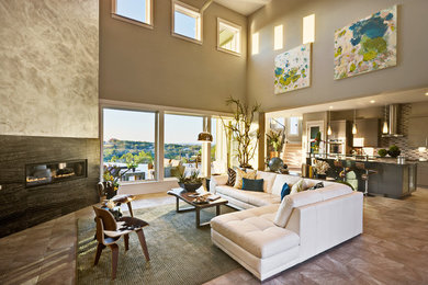 This is an example of a large contemporary open concept living room in Austin with grey walls, a corner fireplace, porcelain floors, a plaster fireplace surround and a wall-mounted tv.