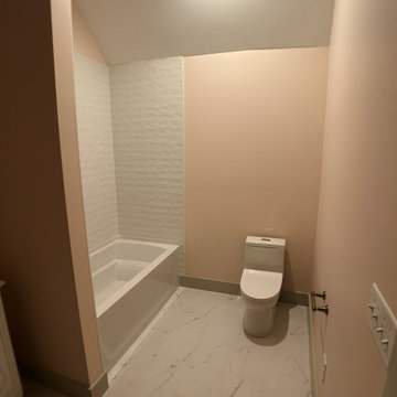 Elegant Guest Bath: Soft Terracotta Walls, Marble Vanity, and Modern Black Fixtu
