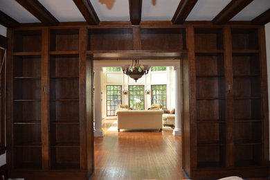 Inspiration for a medium tone wood floor study room remodel in New York