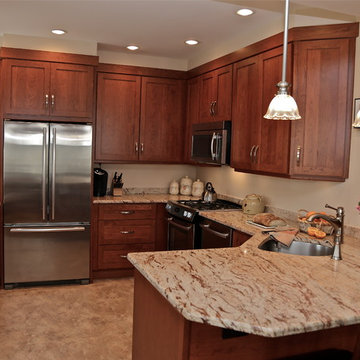 Warm Wood Kitchen Remodel | Angled Granite Island & Integrated Display Cabinets