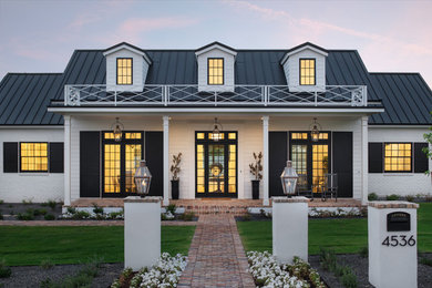 Large country brick floor and brown floor single front door photo in Phoenix with white walls and a glass front door
