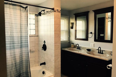Mid-sized transitional gray tile, white tile and ceramic tile ceramic tile and beige floor bathroom photo in Phoenix with black cabinets, beige walls, granite countertops and an integrated sink
