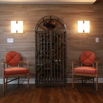 Wine Rack Flanked by Sconces and Rattan Chairs