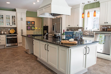Inspiration for a large transitional u-shaped porcelain tile eat-in kitchen remodel in Detroit with an undermount sink, recessed-panel cabinets, white cabinets, granite countertops, multicolored backsplash, glass tile backsplash, stainless steel appliances and an island