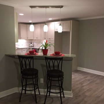 Kitchen countertops with bar stools and accent lightingCarbon Custom homes xHom