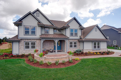 Large arts and crafts gray two-story concrete fiberboard exterior home photo in Milwaukee with a shingle roof
