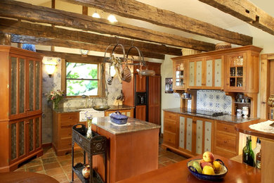 Mid-sized cottage u-shaped terra-cotta tile enclosed kitchen photo in Philadelphia with a farmhouse sink, glass-front cabinets, light wood cabinets, granite countertops, white backsplash, ceramic backsplash, paneled appliances and an island