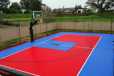 This is an example of a large transitional full sun backyard outdoor basketball/tennis/multi-game court in Other.