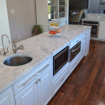 Traditional Spacious White Kitchen with Custom Island and Booth