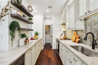 Eat-in kitchen - mid-sized eclectic galley bamboo floor and brown floor eat-in kitchen idea in New Orleans with an undermount sink, recessed-panel cabinets, white cabinets, marble countertops, multicolored backsplash, ceramic backsplash, stainless steel appliances and multicolored countertops