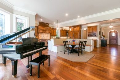 Inspiration for a large medium tone wood floor eat-in kitchen remodel in Charleston with stainless steel appliances and an island