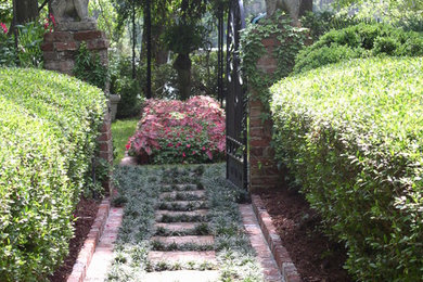 Photo of a mid-sized traditional backyard shaded formal garden for summer in Charleston.