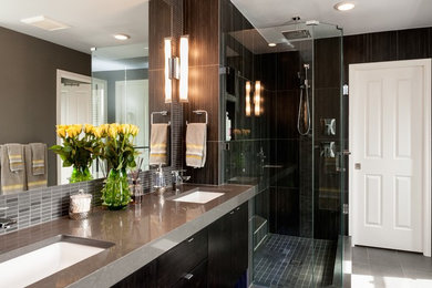Large master gray tile corner shower photo in Seattle with dark wood cabinets and gray walls
