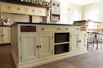 Photo of a large country eat-in kitchen in Other with beaded inset cabinets, panelled appliances and with island.
