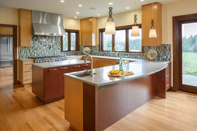 Large trendy u-shaped light wood floor and brown floor eat-in kitchen photo in Seattle with an undermount sink, flat-panel cabinets, light wood cabinets, quartz countertops, multicolored backsplash, ceramic backsplash, stainless steel appliances and an island