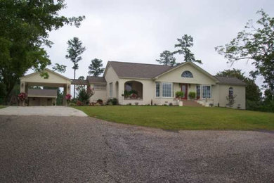 Inspiration for a mid-sized yellow one-story stucco exterior home remodel in Other