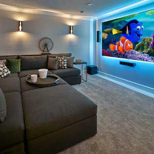 Example of a large transitional enclosed carpeted and beige floor home theater design in Edmonton with gray walls and a wall-mounted tv