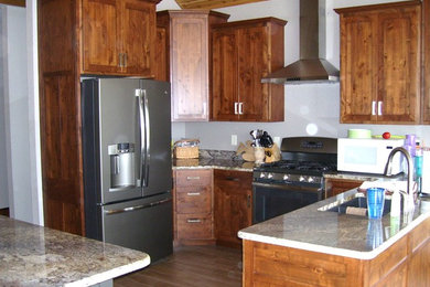 Mid-sized mountain style u-shaped eat-in kitchen photo in Cedar Rapids with flat-panel cabinets, medium tone wood cabinets and an island